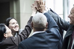 Mixed race group of business people in an informal team building meeting.